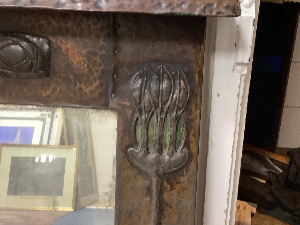 A large Art Nouveau hammered copper overmantel mirror, width 120cm, height 78cm